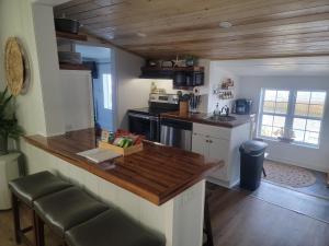 a kitchen with a wooden counter top in a room at Pirates fishing cottage in Cedar Point