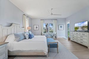 a bedroom with a bed and a dresser and a desk at Taj Duval, Sleeps 14, Pool, Lux in Jacksonville Beach