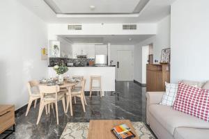 a living room with a table and a couch at Frank Porter - Burj Al Nujoom in Dubai