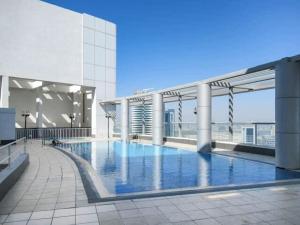 a large swimming pool on top of a building at Frank Porter - Burj Al Nujoom in Dubai