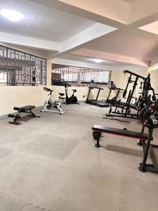 a gym with several exercise equipment in a room at The Manna at Valley Heights Apartments in Kilimani in Nairobi
