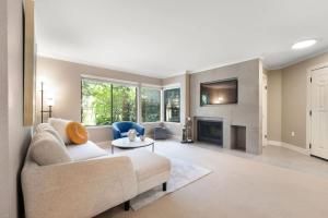 a living room with a couch and a fireplace at 115 Modern and Serene Min to Downtown in Bellevue