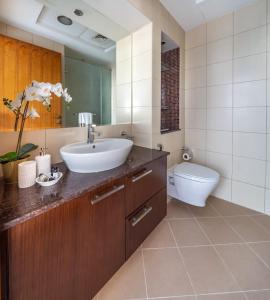 a bathroom with a sink and a toilet at Frank Porter - Bay Square in Dubai