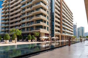 a large apartment building with a pool in front of it at Frank Porter - Bay Square in Dubai
