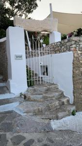 un escalier avec un portail blanc et quelques marches dans l'établissement THE OLIVE MILL GUEST HOUSE, à Lefkes