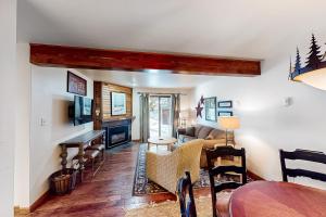 a living room with a couch and a table at Timber Run in Steamboat Springs