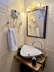 a bathroom with a sink and a mirror at Hotel Fjorr in Prizren