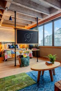 a room with a chalkboard and a bed and a table at Treehouse Hotel Manchester in Manchester