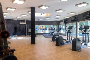 a gym with treadmills and ellipticals in a room at Frank Porter - Al Sidir 2 in Dubai