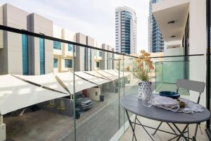 a table on a balcony with a view of a city at Frank Porter - Pantheon Elysee II in Dubai