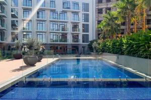 a large swimming pool in the middle of a building at Frank Porter - Pantheon Elysee II in Dubai