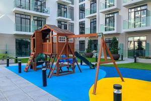 a playground in front of a building at Frank Porter - Pantheon Elysee II in Dubai