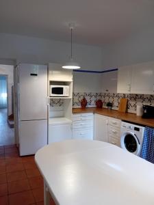 a kitchen with white appliances and a white counter top at Apartamento Plaza San Francisco in Trujillo