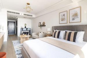 a bedroom with a large bed and a living room at Frank Porter - Goldcrest Views 2 in Dubai