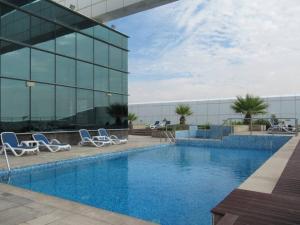 a swimming pool in front of a building at Frank Porter - Goldcrest Views 2 in Dubai