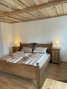 a bedroom with a large bed with two night stands at Ferienhaus Linde in Warmensteinach