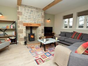 a living room with a couch and a fireplace at 4 Bed in Brassington 47450 in Brassington