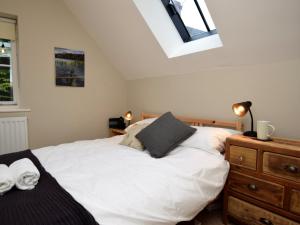 a bedroom with a large white bed and a dresser at 4 Bed in Brassington 47450 in Brassington
