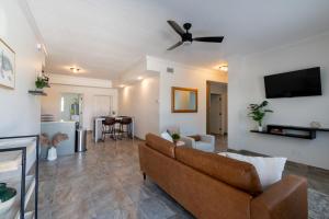 a living room with a couch and a ceiling fan at Luxury 2BD 2BTH Condo 5 in Cocoa Beach