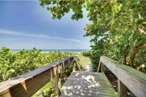 a wooden boardwalk leading to the beach at Luxury 2BD 2BTH Condo 5 in Cocoa Beach