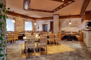 a restaurant with chairs and tables in a room at Hotel Ladenmühle in Kurort Altenberg