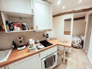 a kitchen with white cabinets and a counter top at Studio coeur de Grasse in Grasse
