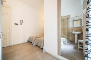 a white bathroom with a sink and a toilet at B&b Glamour in Palermo