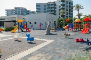 a playground with slides and play equipment in a building at Frank Porter - MAG 560 in Dubai