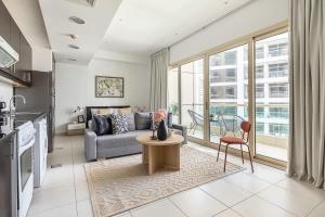 a living room with a couch and a table at Frank Porter - Royal Oceanic in Dubai