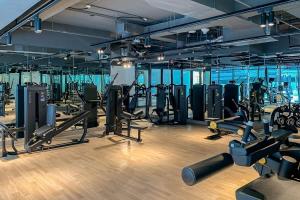 a gym with lots of treadmills and machines at Frank Porter - Binghatti Creek in Dubai