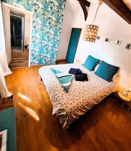 a bedroom with a bed with blue pillows at Casa Baia Hendaye in Hendaye