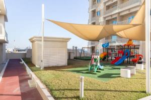 a playground on the side of a apartment building at Frank Porter - Suburbia in Dubai