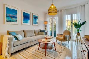 a living room with a couch and a table at Casita Bonita - with private garden near beach in Jávea in Jávea