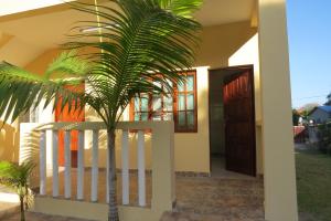 un palmier devant une maison dans l'établissement Garden House, à Lopes