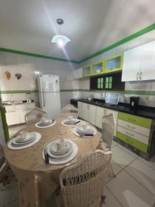 kuchnia z drewnianym stołem i krzesłami oraz kuchnia z w obiekcie Casa de Lazer Praia e Piscina w mieście São José da Coroa Grande