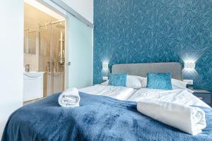 1 dormitorio azul con 1 cama grande y paredes azules en Mariahilfer Boutique Rooms - Virtual Reception & Self-Checkin en Viena