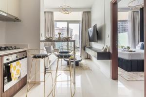a kitchen with two chairs and a kitchen with a bed at Frank Porter - Reva Residences in Dubai