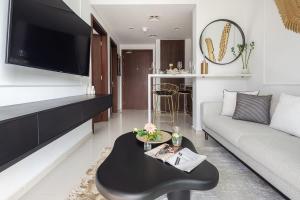 a living room with a couch and a table at Frank Porter - Reva Residences in Dubai