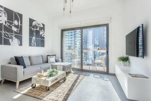 a living room with a couch and a table at Frank Porter - Marina Views Tower B in Dubai