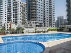 a large swimming pool in front of some tall buildings at Frank Porter - Marina Views Tower B in Dubai