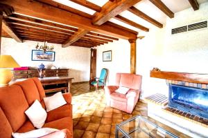 a living room with a couch and a fireplace at Villa confortable à Milhars avec piscine privée in Milhars