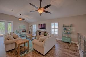 a living room with two couches and a ceiling fan at 4BD 3BR Pool Paradise 1 mile from Beach & Downtown in Saint Augustine