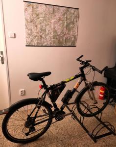 a bike parked in a room with a map on the wall at Apartmán Absolon in Blansko