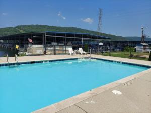 a large swimming pool with two chairs in front of a building at Cute & Cozy Houseboat Near Chattanooga in Haletown