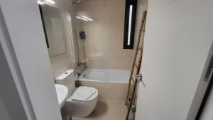 uma casa de banho com um WC, um lavatório e uma banheira em RentalSevilla La Salle em Sevilha