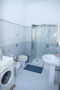 a bathroom with a shower and a toilet and a sink at Casa Mia, vacanze in Marsala