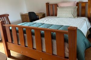 a bedroom with a wooden bed with a wooden frame at Casa Amarela in Faro