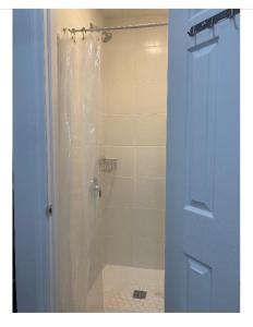 a bathroom with a shower with a shower curtain at Modern GuestHouse Ironbound Newark with KITCHEN-FastTrainToNYC-OneStopToAirport in Newark