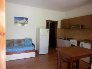 a kitchen with a refrigerator and a table in a room at Il Gamberetto in Principina a Mare