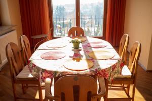 a dining room table with a tablecloth and chairs with a window at Herrlicher Ausblick über Wien in Vienna